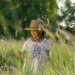 A young girl in a field with Cattails