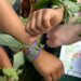 Children showing handmade leaf bracelets on their wrists