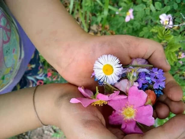 Girl holding flowers.