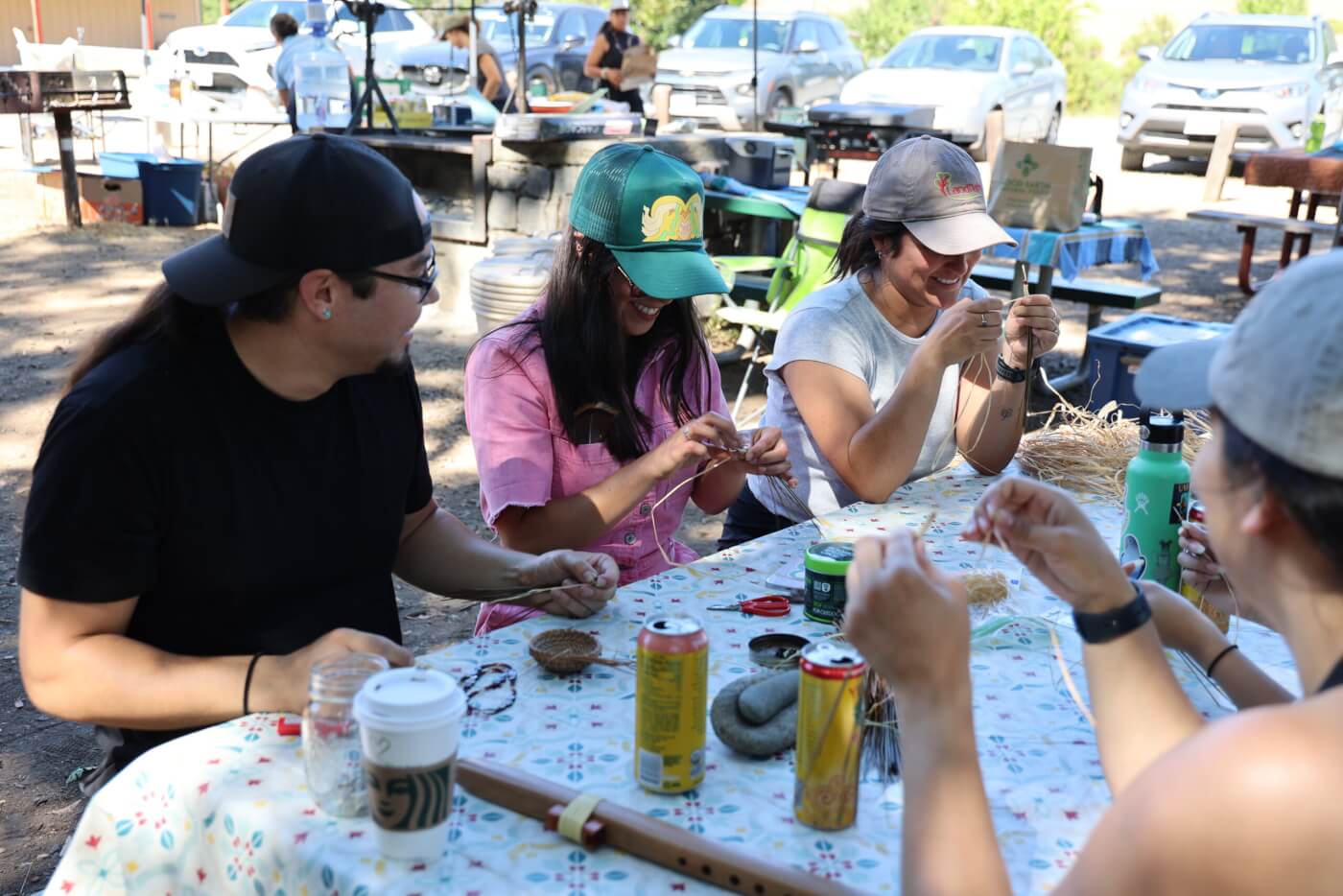 A group of people weaving pine needle baskets.