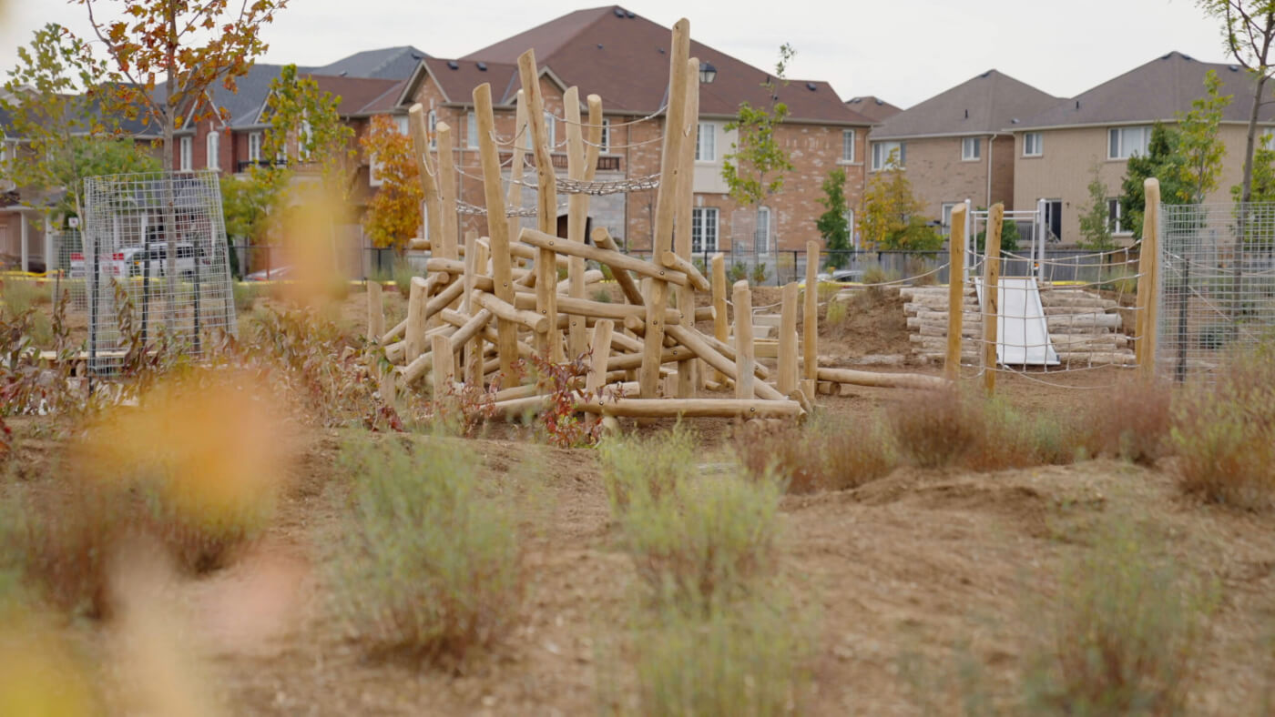 Nature Exploration Area features multi-level play structure built from logs stripped of bark, and ropes used for horizontal and vertical netting.