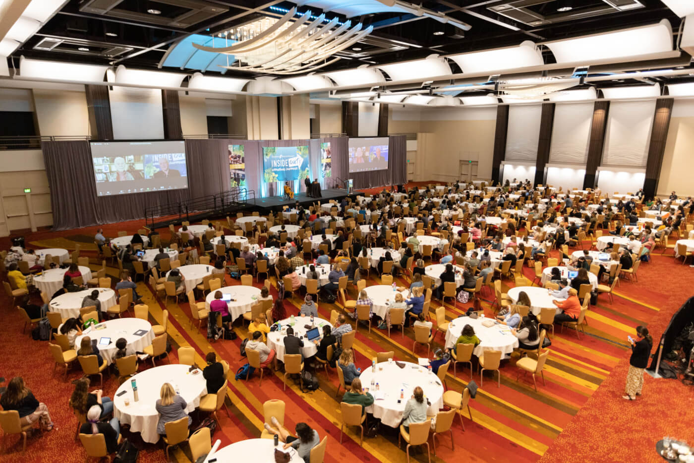 C&NN conference with tables, people and speakers all setup,