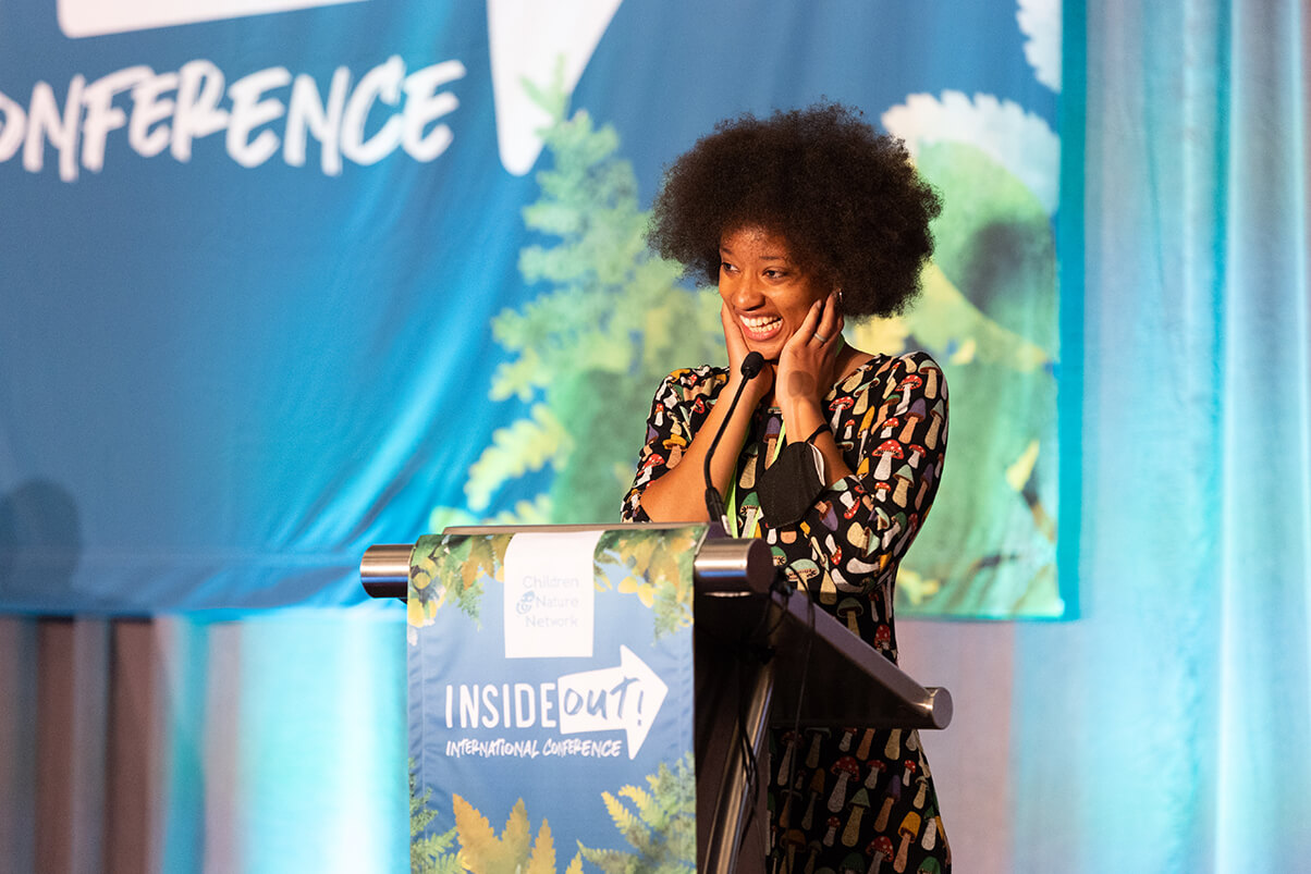Atiya Wells accepts her Richard Louv Prize during the final day of the Inside-Out International Conference