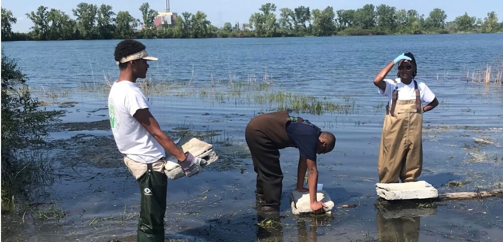 Older teens cleaning out river.