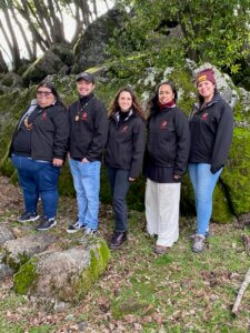 Group photo of five Redbud Resource Group staff members smiling together outdoors.