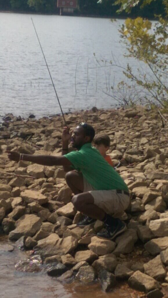 Hunter  teaching a child how to fish.