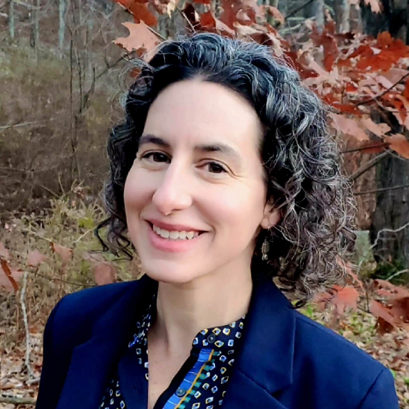 bio photo of woman outdoors with fall leaves in the background