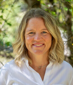 Headshot of Katie Cox smiling outside