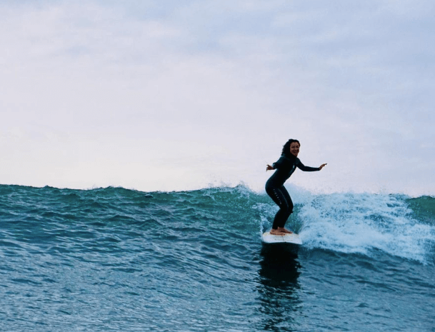 Inside-Out Youth Advisory Council member Kimiko Russell-Halterman surfing.
