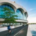 A biker travels along a bike path bordering Lake Monona and the Monona Terrace Community and Convention Center in Madison, Wisconsin.