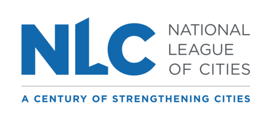 Logo for the National League of Cities (NLC), featuring large blue letters ‘NLC’ on a black background, with the words ‘National League of Cities’ in gray to the right and the tagline ‘A Century of Strengthening Cities’ beneath.