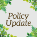 Square graphic with green watercolor leaves framing the corners and the words “Policy Update” in large brown serif text centered on a light gray background.