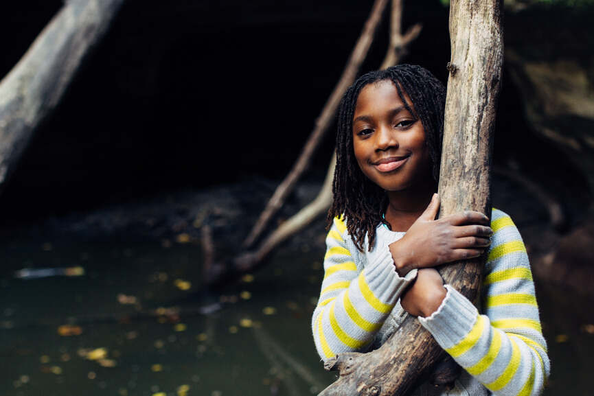 Girl hugging tree.