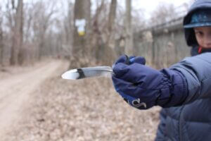 Kid playing with feather.