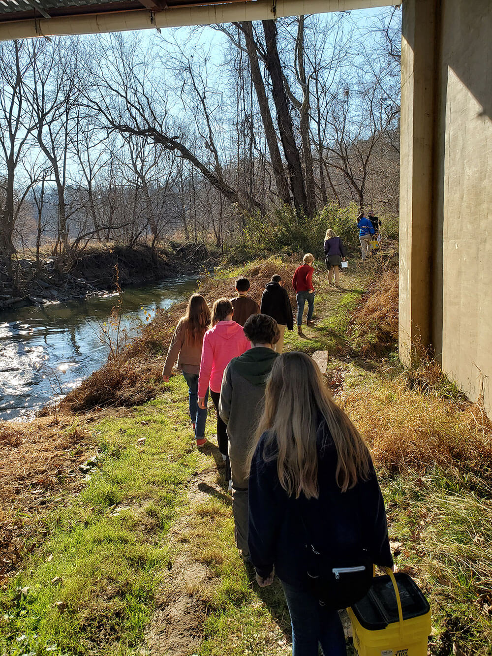 Teen participants in the Young Naturalists program sample the Swannanoa River for mudpuppy salamanders in 2019.