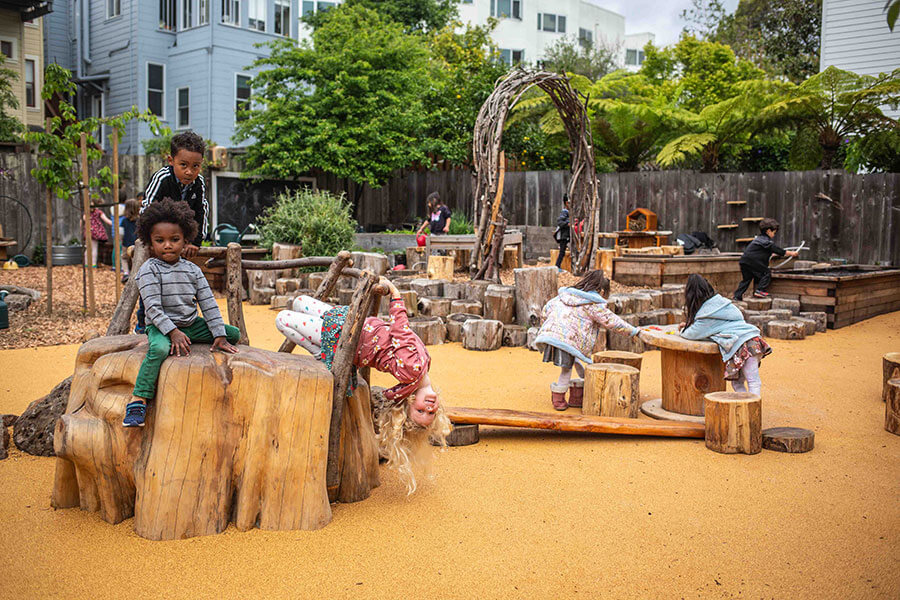 Kids playing on wooden playground in San Francisco.