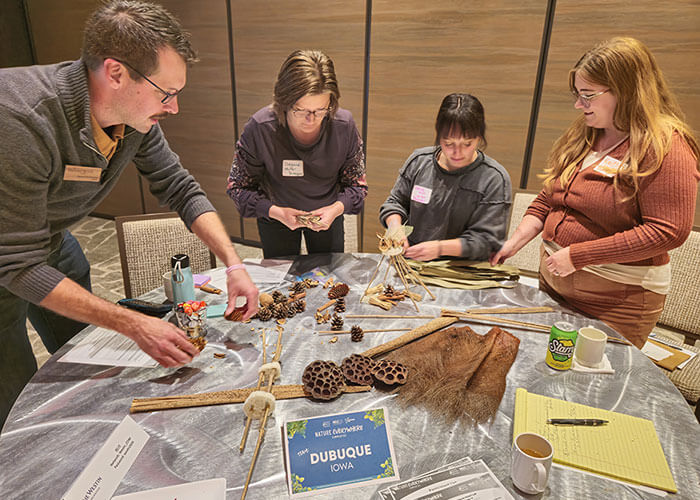 Group from Dubuque, Iowa creating outdoor activities on a table.