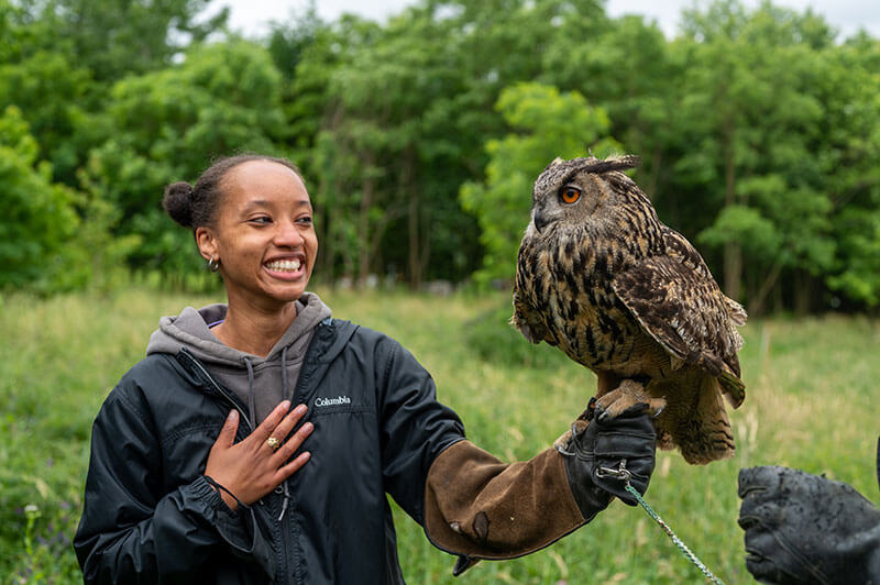 Wells with an owl. BLISS Meadows helps people learn about and connect with wildlife, as well as being a home to goats, chickens, and bees. Photo courtesy of Backyard Basecamp.