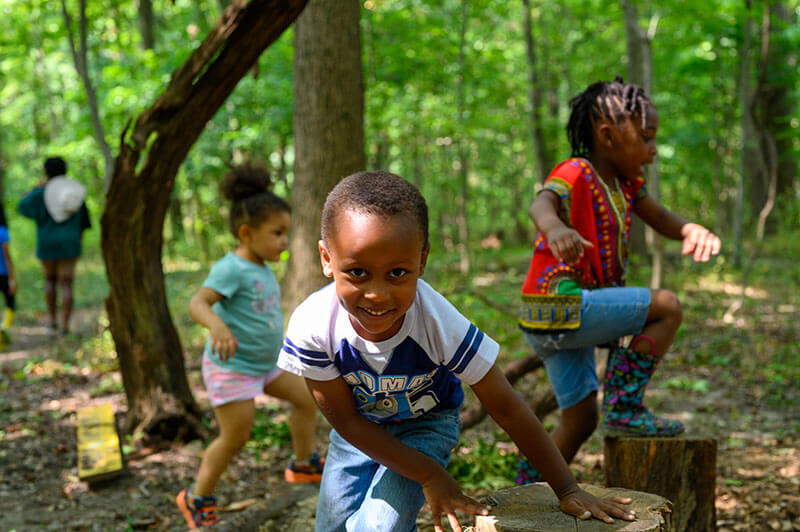 Children enjoy nature-based play at BLISS Meadows. Photo courtesy of Backyard Basecamp.