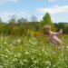 Girl running through meadow.