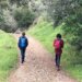 two teenagers walking on a path