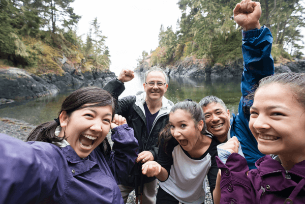 Family posing for a photo by a river.