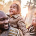 family smiling and walking in the woods