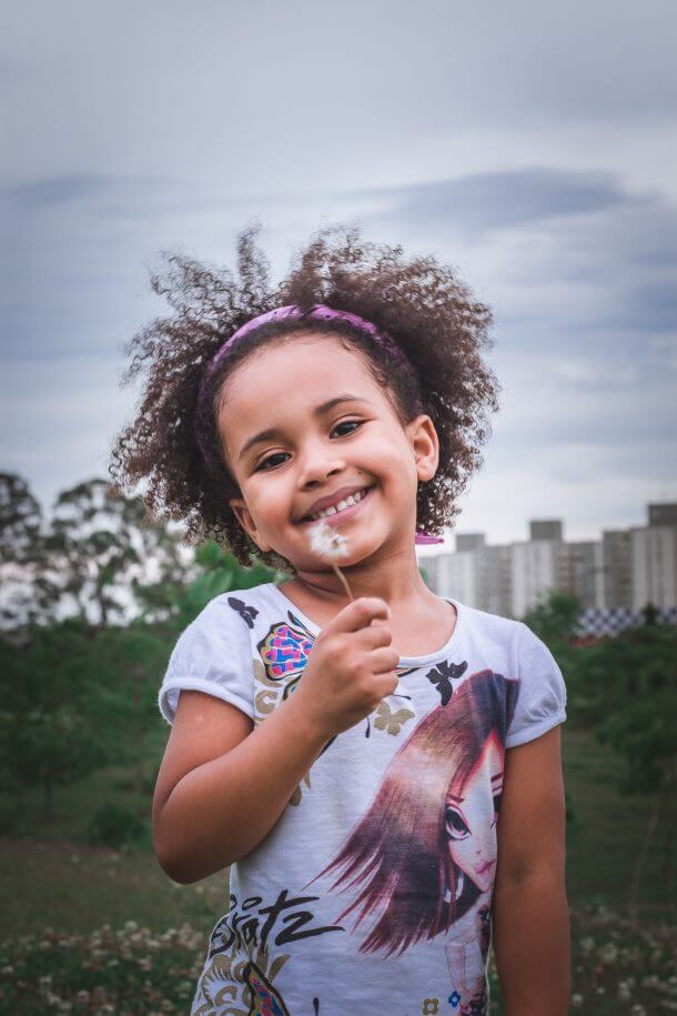 Girl holding dandelion
