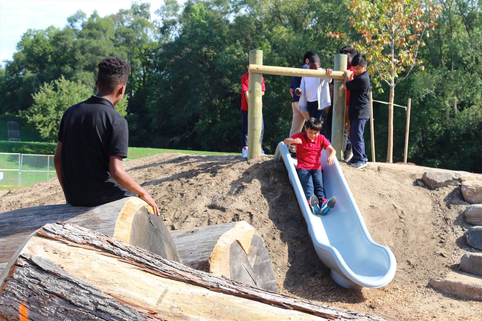 Children playing by slide.