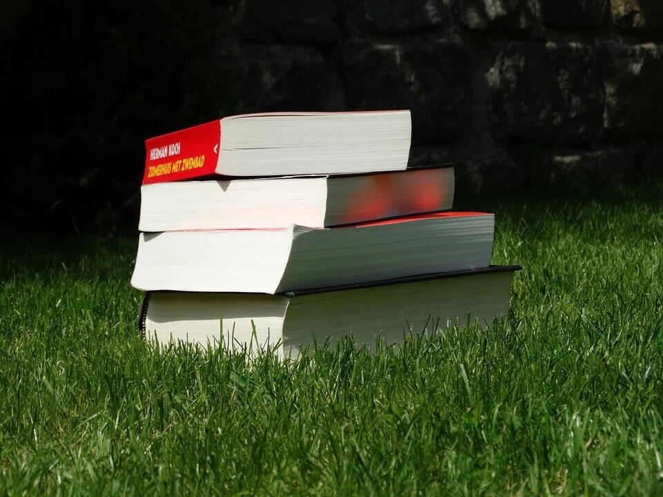 stack of books on grass