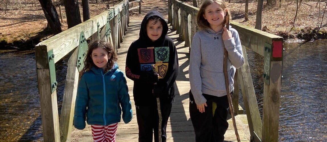 three kids on a dock