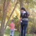 parent with child walking in park