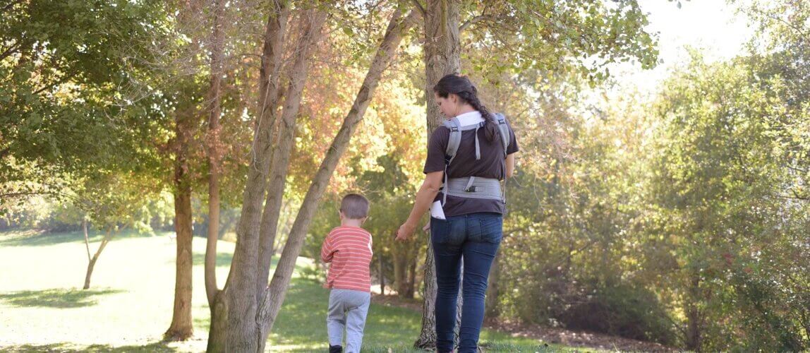 parent with child walking in park