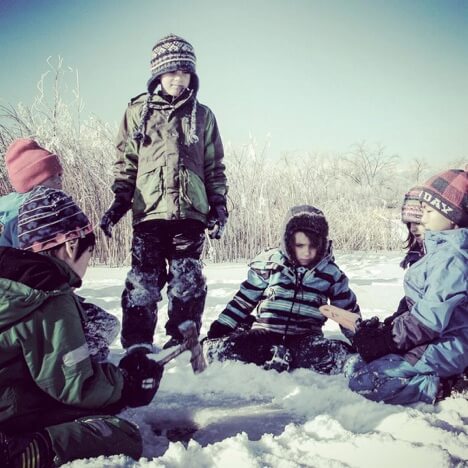 Kids standing together in snow.