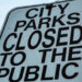 sign that says city parks closed to the public