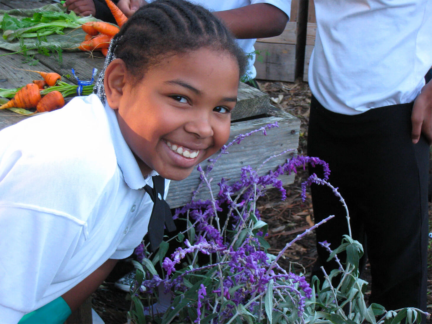 Girl smiling with flowers.
