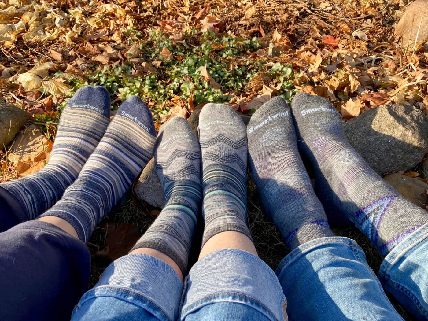photo of three pairs of feet, wearing Smartwool socks