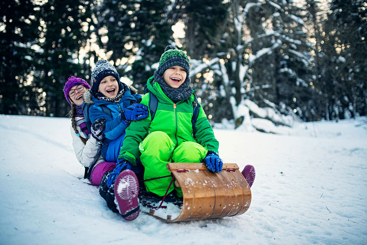 Three kids on Snow Sled