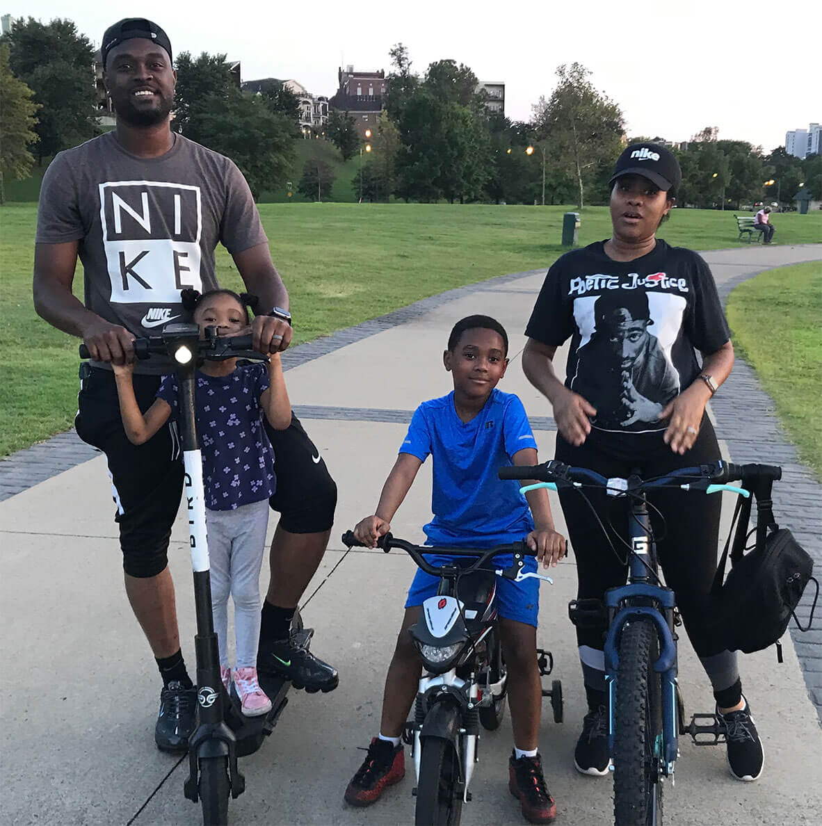 Group of adults with kids on bikes.