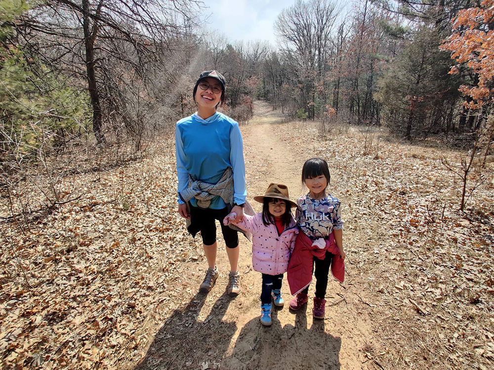 Tiffany and her kids on a path.