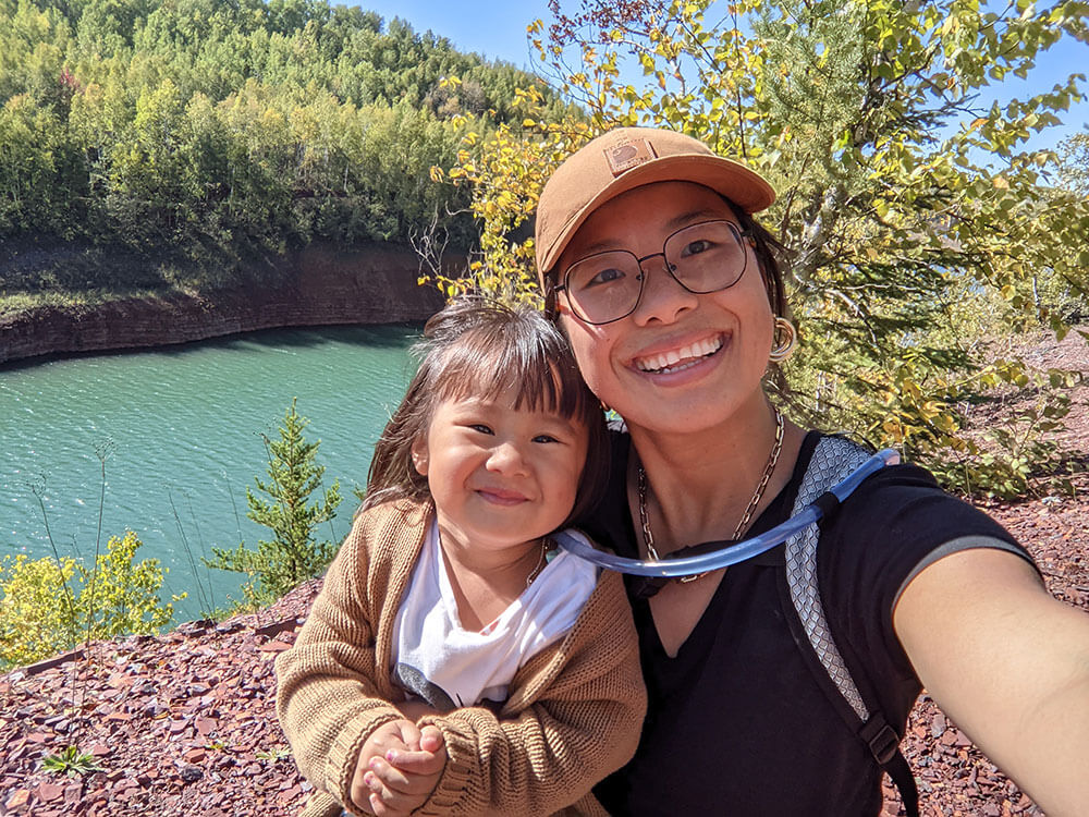 Tiffany and Maria smiling next to a river.